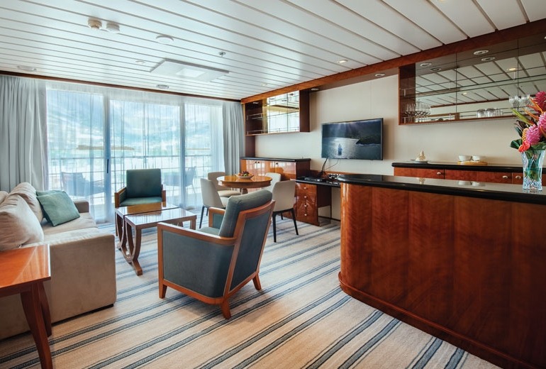 Living Room view of Owner's Suite #7002 aboard the luxury small-shop m/s Paul Gauguin