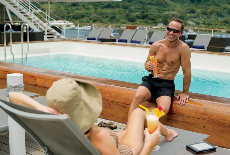 Guests enjoying some time at the m/s Paul Gauguin's pool.