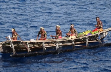 Dugout canoe with samarai islanders in papua new guinea