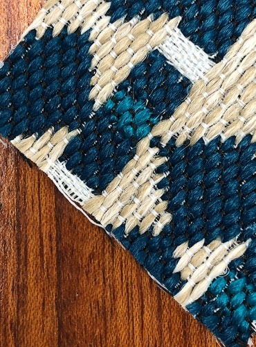 A wood grain sample paired with a tan and blue jute fabric swatch.